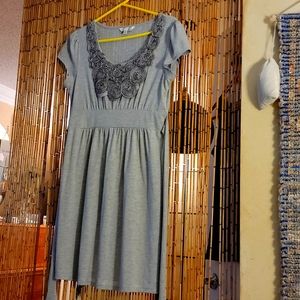 Gray Dress with flower design on front. Size Large but fits Medium.